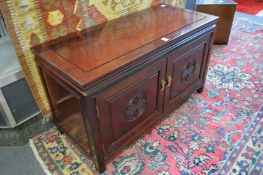 A Chinese hardwood low two door cabinet.
