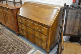 A 19th century style French bureau with drop flap and three long drawers.
