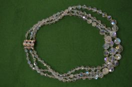 A crystal three row necklace.