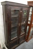 A stained pine display cupboard or bookcase.