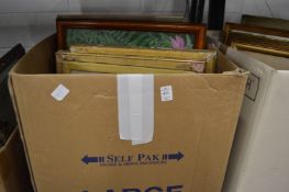 A box of various paintings and prints.