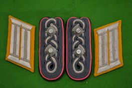 Two pairs of military lapel badges.