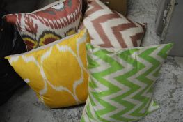 Decorative silk and feather filled cushions.