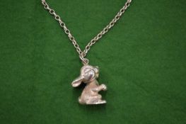 A cast silver pendant and chain.