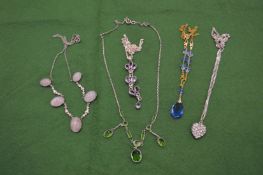A silver and crystal heart shaped pendant and chain and various other necklaces.