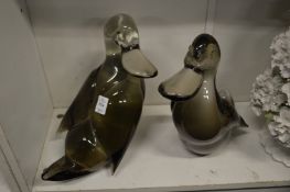 Two large glass models of ducks.
