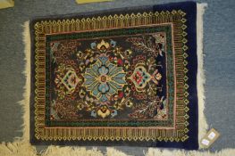 A small Persian rug 90cm x 70cm.