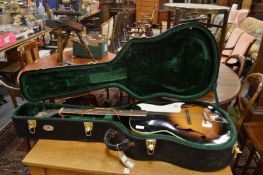 A jazz acoustic guitar in travelling case.