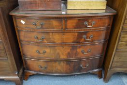 A mahogany bow front chest of drawers.