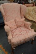 A Georgian style wing armchair.