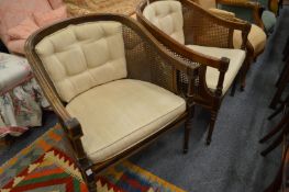 A pair of Bergere style armchairs.