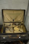 Dressing case containing part fitted set of silver topped dressing table jars etc.