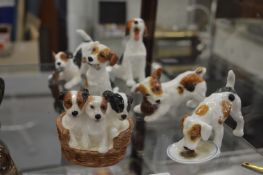 A good collection of Royal Doulton porcelain figures of playful puppy dogs.