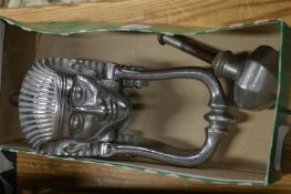 An Egyptian revival chrome plated door knocker and similar door knob.