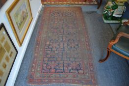 An old Persian rug, worn, 225cm x 110cm.