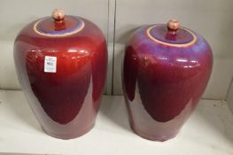 A large pair of Chinese flambe glazed jars and covers.
