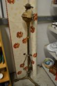 A brass floor standing oil lamp.