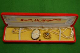 Pearl necklace, yellow metal brooch and a cameo brooch.