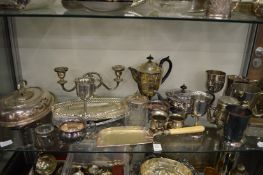 A shelf of various plated items.