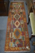 A Kilim runner 200cm x 63cm.