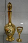 A Venetian gilt decorated liqueur bottle and glass.