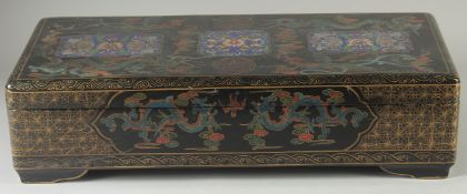 A LARGE CHINESE BLACK LACQUERED WOOD RECTANGULAR BOX, painted with panels of foliate motifs and