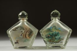 A PAIR OF CHINESE REVERSE GLASS PAINTED SNUFF BOTTLES AND STOPPERS, finely painted with scenes of