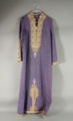 AN ARAB LILAC SILK HOUSE COAT / ROBE, the embroidered collar with buttoned front and similar