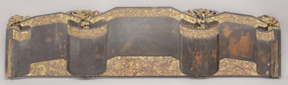 A LARGE CHINESE LACQUERED WOOD PANEL / HEADBOARD, with carved and gilded bands of flora, 202.5cm x