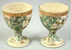 A PAIR OF JAPANESE SATSUMA EGG CUPS, with foliate decoration, 6.5cm high.