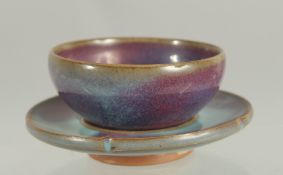 A CHINESE JUN WARE CUP AND SAUCER, cup 8cm diameter, saucer 10.5cm diameter.