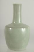 A CHINESE CELADON GLAZE BOTTLE VASE, 22cm high.