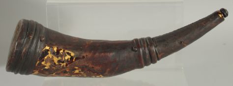 AN ANTIQUE TURKISH LEATHER AND TORTOISESHELL POWDER HORN, 32cm long.