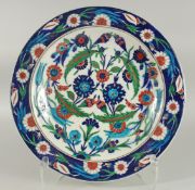 A LARGE OTTOMAN TURKISK GLAZED POTTERY DISH, painted with foliate decoration, 36cm diameter.
