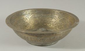 A 19TH CENTURY OTTOMAN BRASS MAGIC BOWL, with engraved calligraphic panels, 20.5cm diameter.