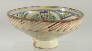 A 19TH CENTURY MOROCCAN POTTERY FOOTED BOWL, 23.5cm diameter.
