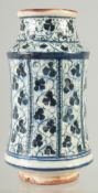 AN ISLAMIC BLUE AND WHITE GLAZED POTTERY MEDICINE JAR, 18.5cm high.