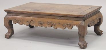 A 19TH CENTURY CHINESE KANG TABLE, with carved frieze on cabriole legs terminating in claw feet,