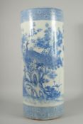 A CHINESE BLUE AND WHITE PORCELAIN WALKING STICK STAND, decorated with a peacock and native flora,
