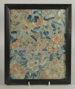 AN EARLY 20TH CENTURY CHINESE EMBROIDERED SILK TEXTILE FRAGMENT, framed and glazed, textile 27cm x