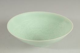 A CHINESE CELADON BOWL, with incised decoration, 20.5cm diameter.