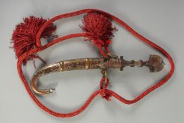 AN ISLAMIC KINDJAL DAGGER, with curving blade and silver overlaid sheath, overall length 44cm.