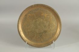 AN ENGRAVED BRASS DISH, 34.5cm diameter.