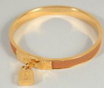 A GOOD HERMES BRACELET with lock, in a Hermes box and bag.