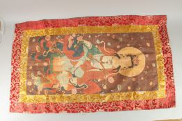 A TIBETAN THANKA on silk. 110cm x 64cm.