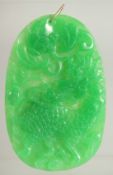 A CHINESE LARGE JADE PENDANT with gold ring. 3.25ins x 2.5ins.