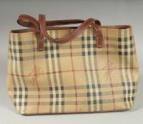 A BURBERRY SMALL HAND BAG, tartan pattern with leather brown straps, with navy dust cover. 32cm