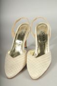 A PAIR OF CHANEL CREAM FABRIC SLING BACK SHOES. Size 38, boxed.