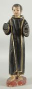 AN 18TH CENTURY CONTINENTAL CARVED WOOD AND PAINTED STANDING MONK with gilded robe.