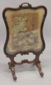 A VICTORIAN MAHOGANY FIRE SCREEN with Brussels tapestry.